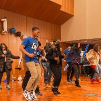 Image of students who attended event dancing to music as DJ gets the party started